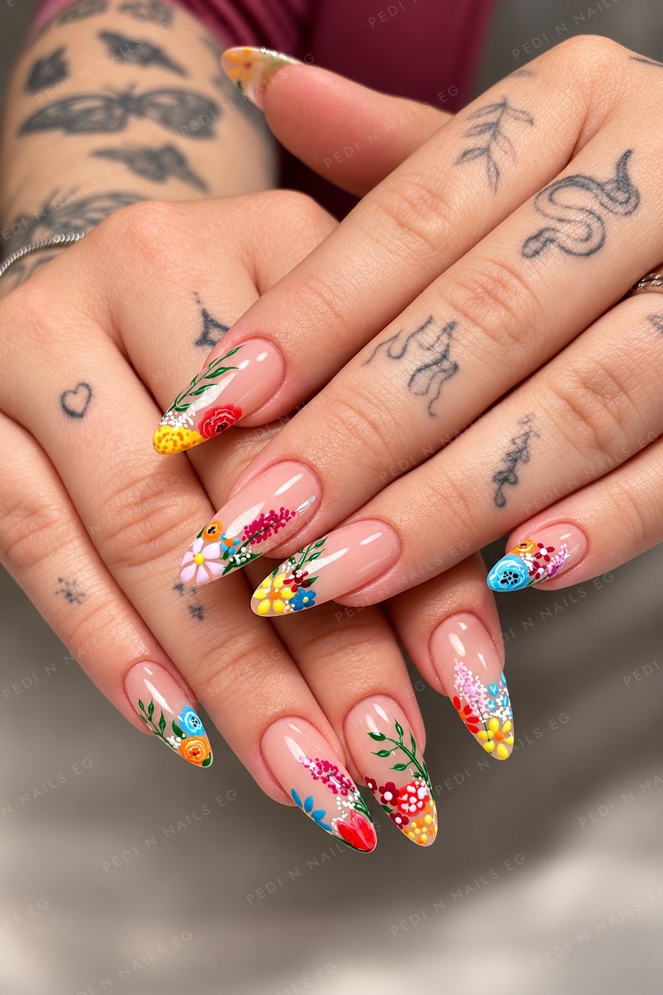 Nude almond nails with hand-painted colourful wildflower tips