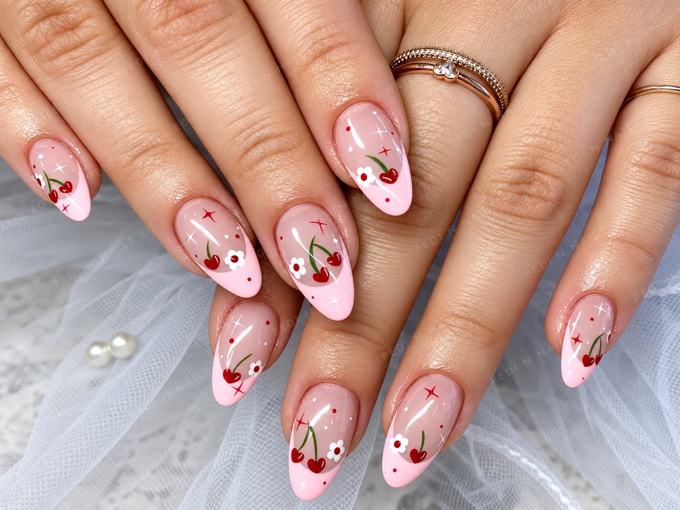 Pink French almond nails with hand-painted cherries and daisies
